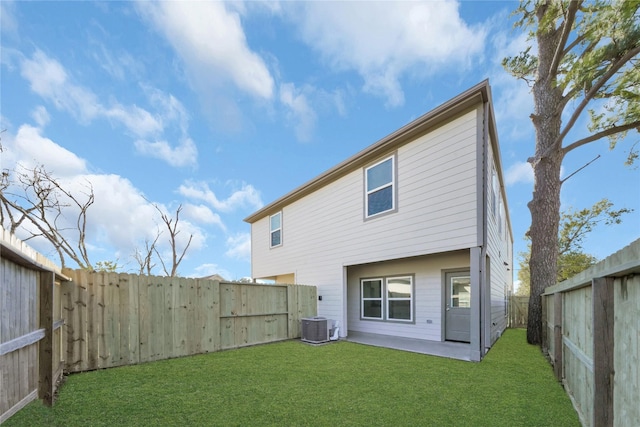 rear view of property featuring a lawn