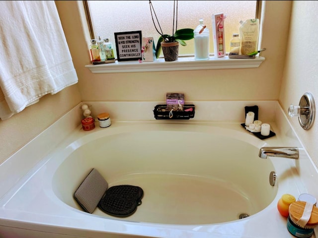 bathroom with a tub to relax in