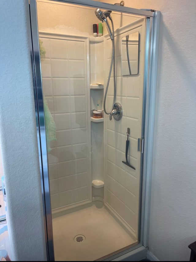 bathroom with a shower with door