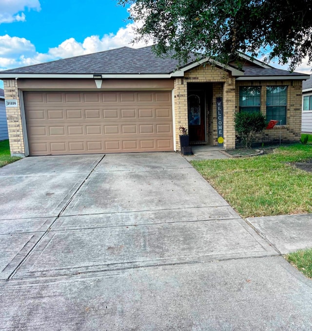 ranch-style house with a front yard and a garage