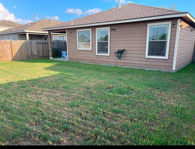 back of house with a lawn