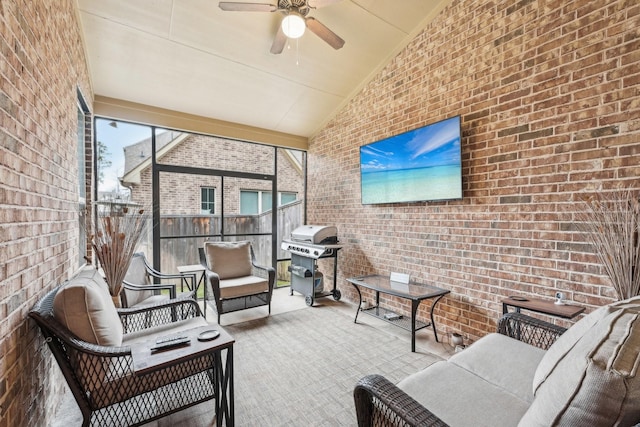 sunroom with ceiling fan and lofted ceiling