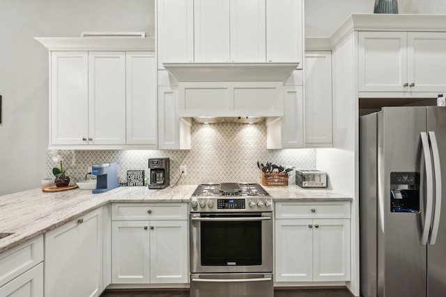 kitchen with stainless steel appliances, backsplash, and white cabinetry