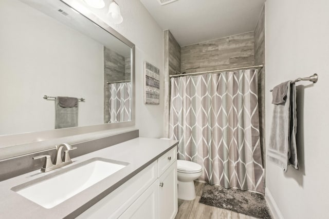 bathroom with toilet, vanity, wood-type flooring, and a shower with shower curtain