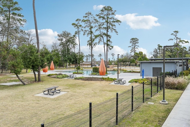 view of community featuring a swimming pool and a yard