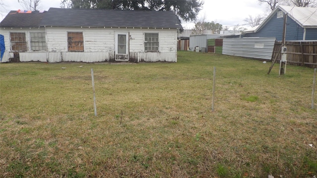 back of house with a lawn