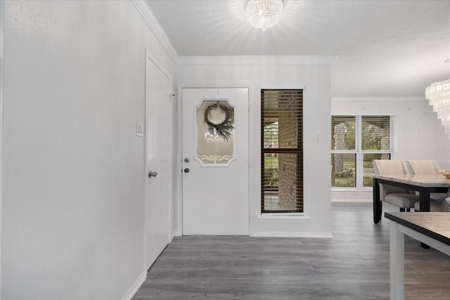 interior space with an inviting chandelier, crown molding, and dark hardwood / wood-style flooring