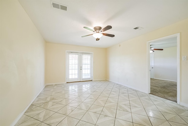 empty room with ceiling fan, french doors, and light tile patterned floors