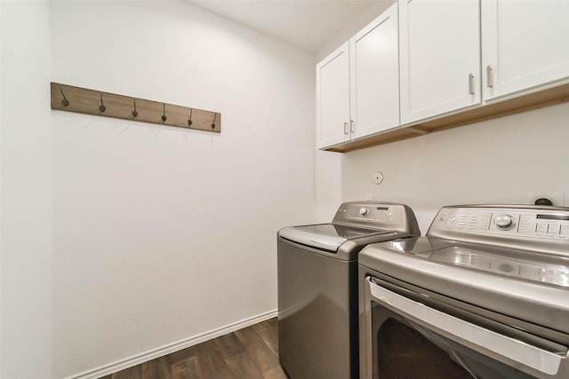 washroom featuring cabinets, dark wood-type flooring, and washer and dryer