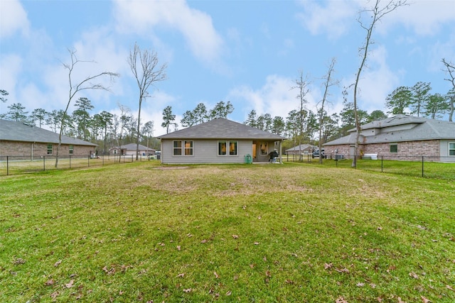 rear view of house with a yard