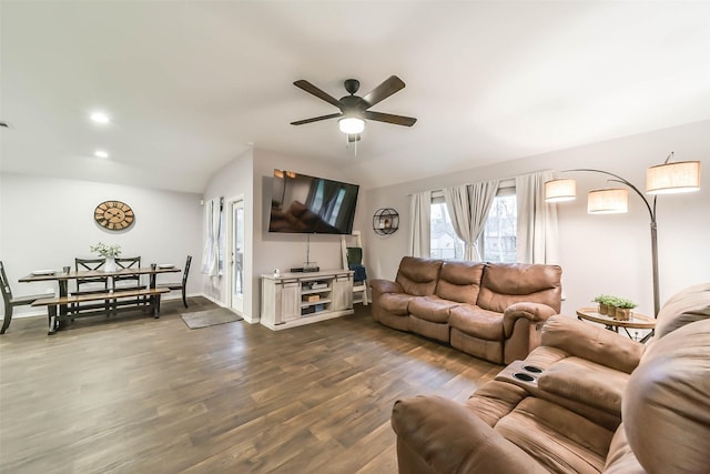 living room featuring dark hardwood / wood-style floors, ceiling fan, and lofted ceiling