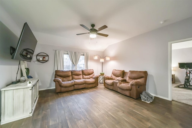 living room featuring ceiling fan, dark wood-type flooring, and vaulted ceiling