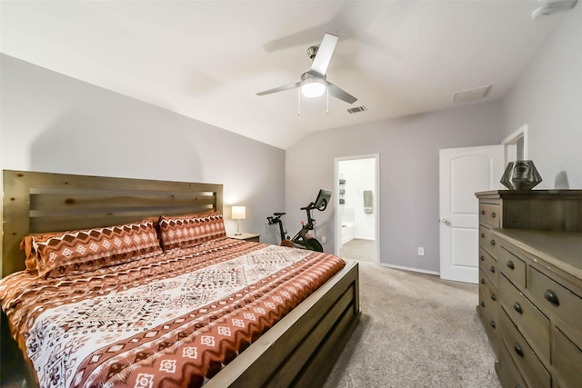 carpeted bedroom with connected bathroom, vaulted ceiling, and ceiling fan