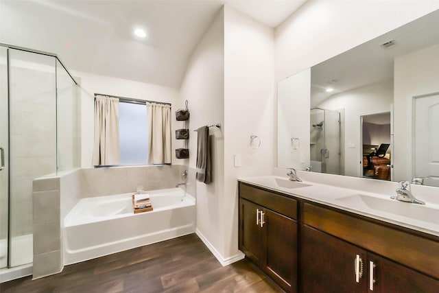 bathroom featuring hardwood / wood-style flooring, vanity, separate shower and tub, and vaulted ceiling