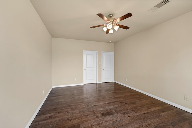 empty room featuring ceiling fan and dark hardwood / wood-style flooring