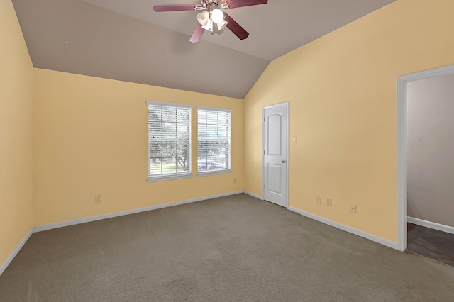 carpeted empty room featuring ceiling fan and lofted ceiling