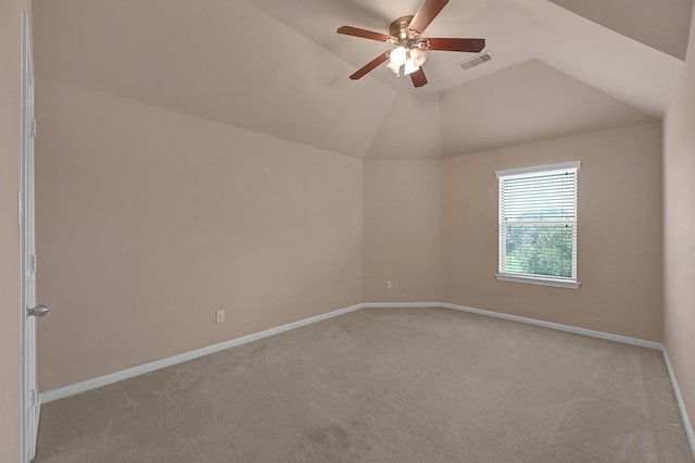 spare room with light colored carpet, ceiling fan, and lofted ceiling