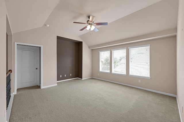 unfurnished bedroom featuring ceiling fan, light carpet, and vaulted ceiling