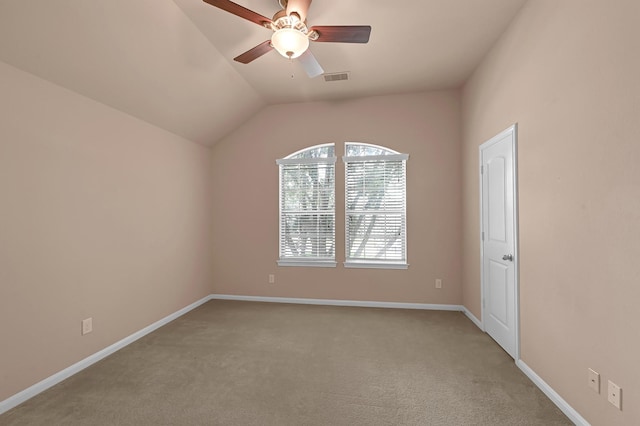 empty room featuring ceiling fan, light colored carpet, and lofted ceiling