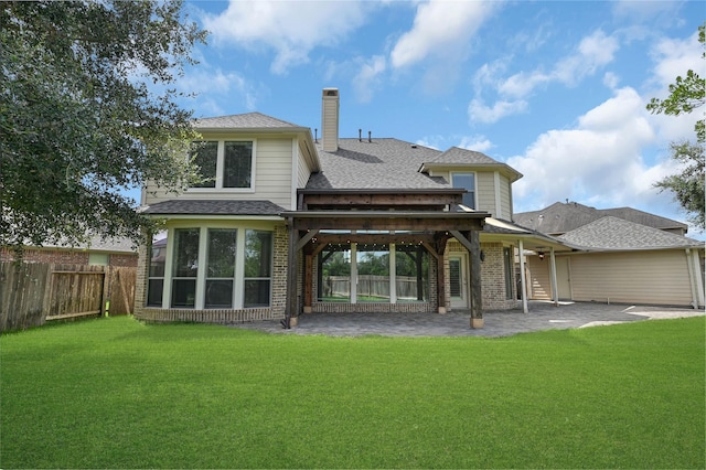 back of house featuring a lawn and a patio