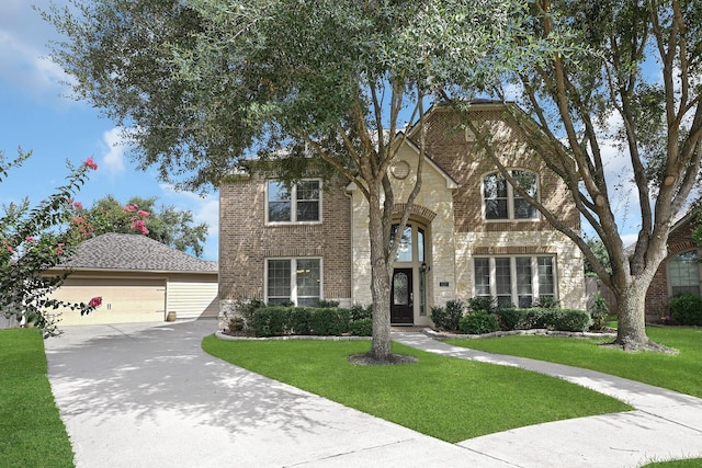 view of front facade featuring a front yard and a garage