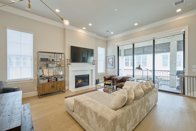 living room featuring crown molding and light hardwood / wood-style floors