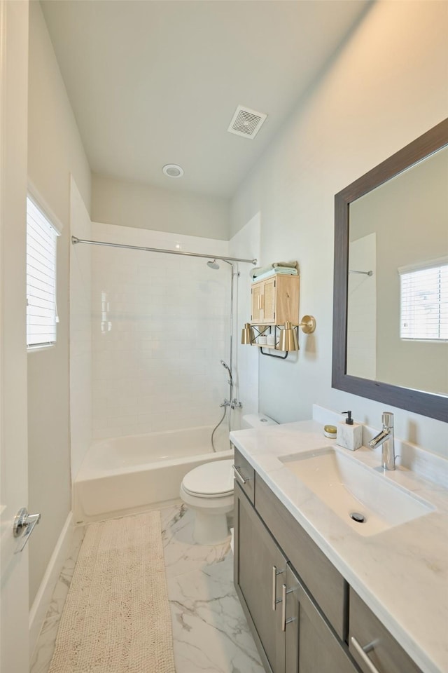 full bathroom featuring vanity, tiled shower / bath combo, plenty of natural light, and toilet