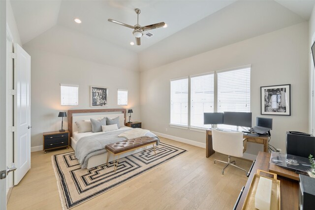 bedroom with ceiling fan, vaulted ceiling, and light hardwood / wood-style flooring