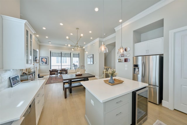 kitchen with wine cooler, a center island, white cabinets, and appliances with stainless steel finishes