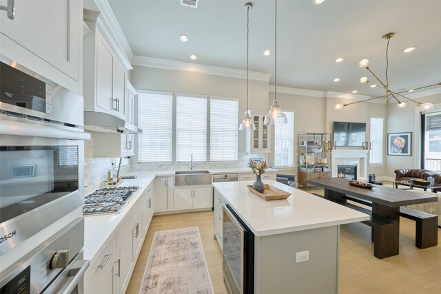 kitchen featuring a center island, white cabinets, and stainless steel gas cooktop