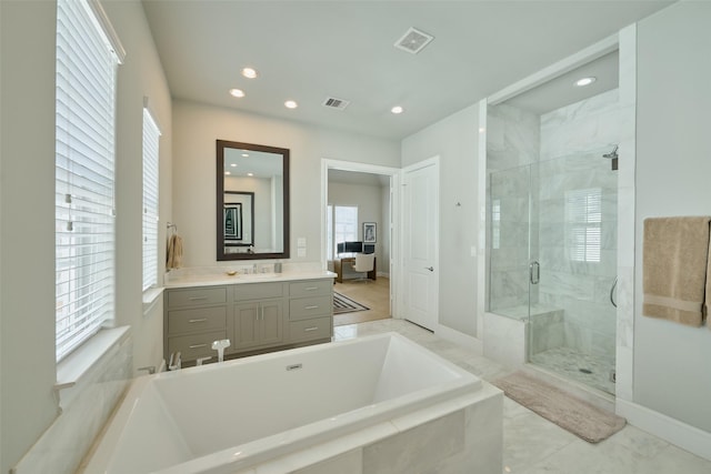 bathroom with vanity and separate shower and tub