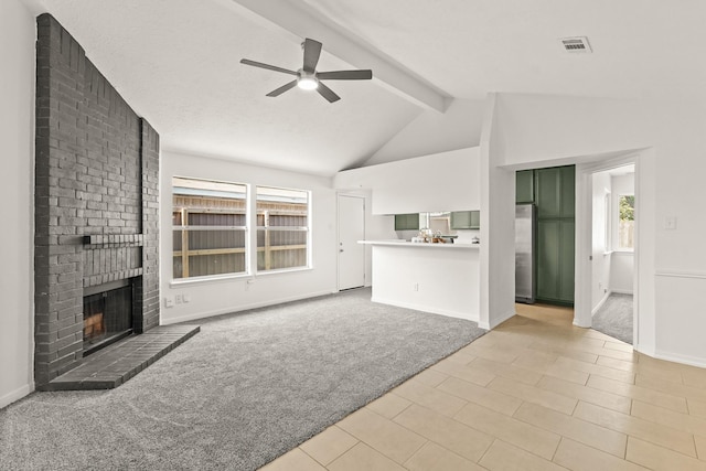 unfurnished living room with light carpet, vaulted ceiling with beams, a brick fireplace, and ceiling fan