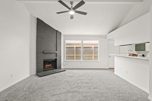 unfurnished living room featuring vaulted ceiling with beams, ceiling fan, a fireplace, and light carpet