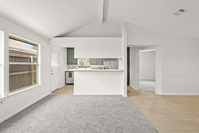 unfurnished living room featuring light carpet and vaulted ceiling with beams