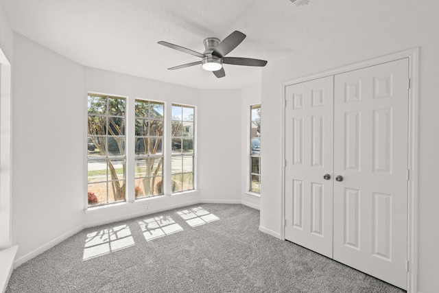 unfurnished bedroom with ceiling fan, a closet, and light carpet