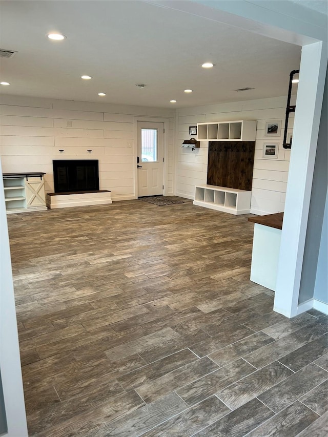 unfurnished living room featuring a large fireplace