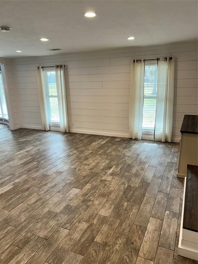 unfurnished living room featuring dark wood finished floors and recessed lighting