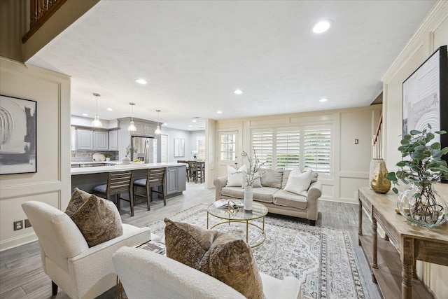 living room featuring crown molding and wood-type flooring