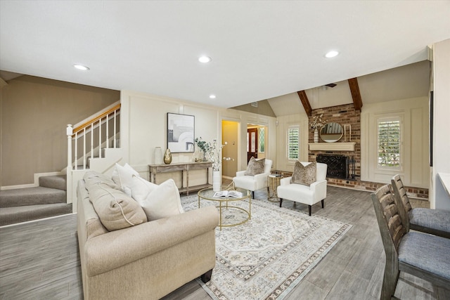 living room featuring a fireplace and vaulted ceiling with beams