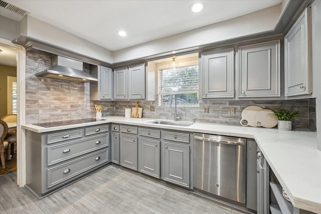 kitchen featuring black electric cooktop, wall chimney exhaust hood, sink, stainless steel dishwasher, and tasteful backsplash