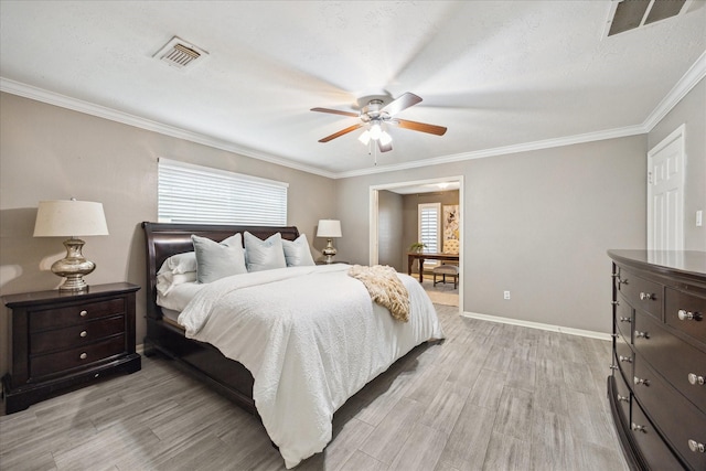 bedroom featuring ceiling fan, crown molding, and light hardwood / wood-style floors