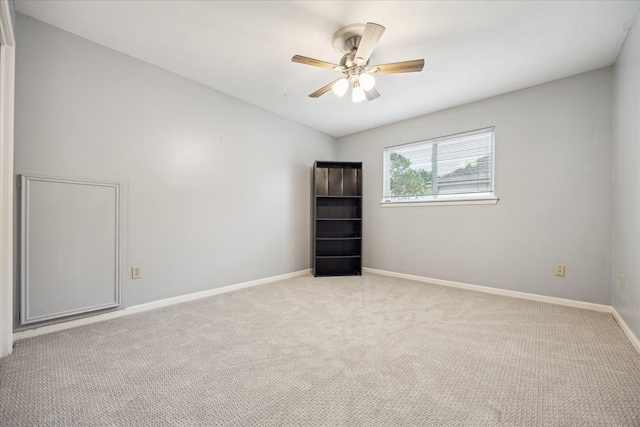 empty room featuring ceiling fan and light colored carpet