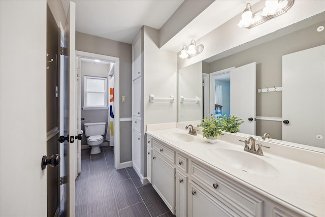 bathroom with toilet and vanity