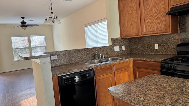 kitchen featuring sink, range hood, kitchen peninsula, black appliances, and ceiling fan with notable chandelier