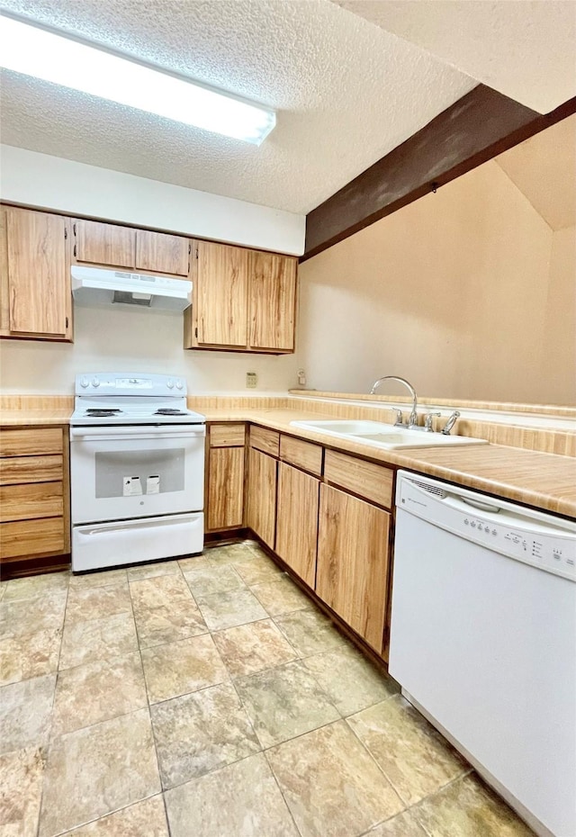 kitchen featuring a textured ceiling, white appliances, and sink