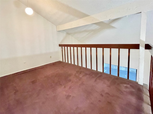 bonus room with carpet, lofted ceiling with beams, and a textured ceiling