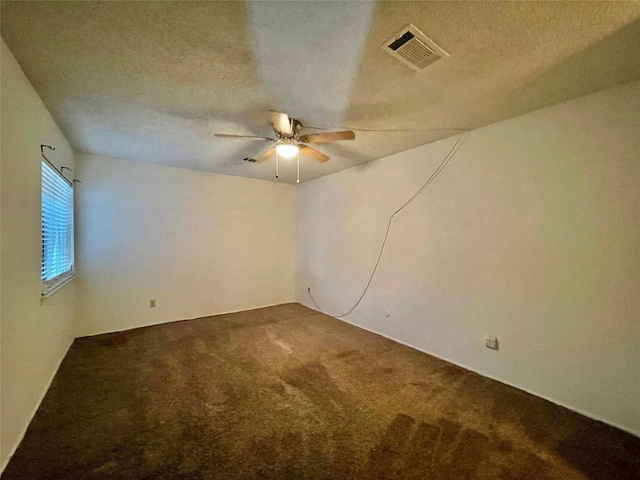 carpeted empty room featuring a textured ceiling and ceiling fan