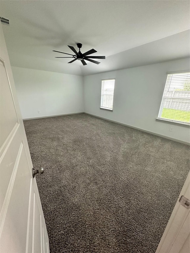 empty room with ceiling fan and carpet