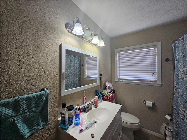 bathroom featuring tile patterned flooring, vanity, and toilet