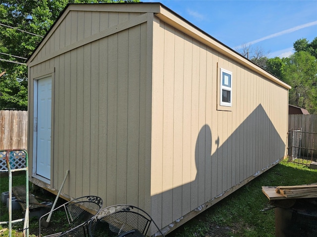 view of side of property with a shed